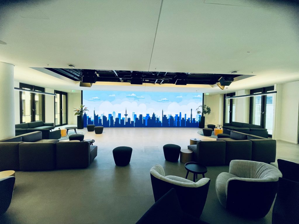 photo of an event location with a digital illustration of a skyline projected onto a screen